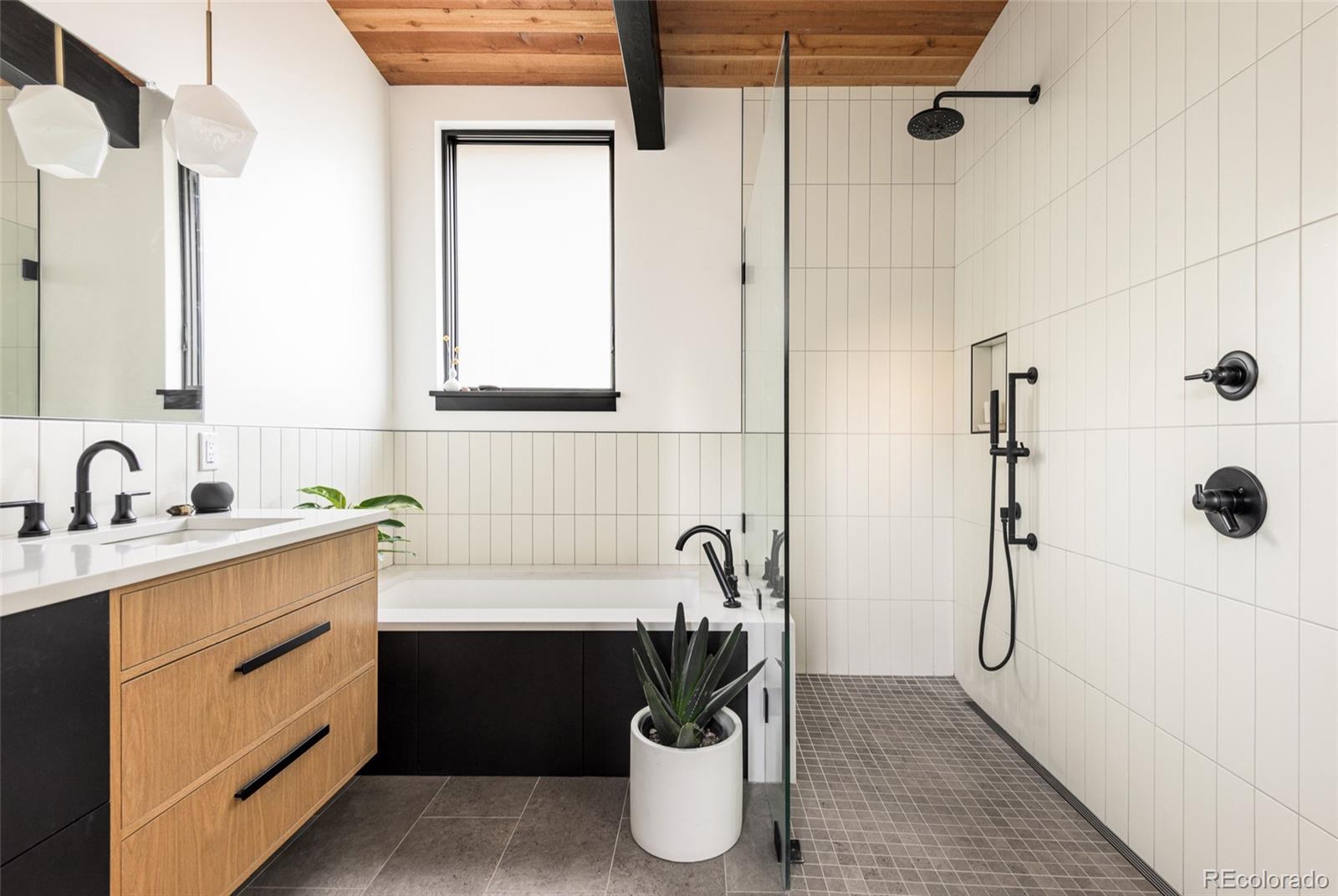2977 Forest Street Denver, CO 80207 - Photo 13 of 23 a bathroom with a shower sink and mirror