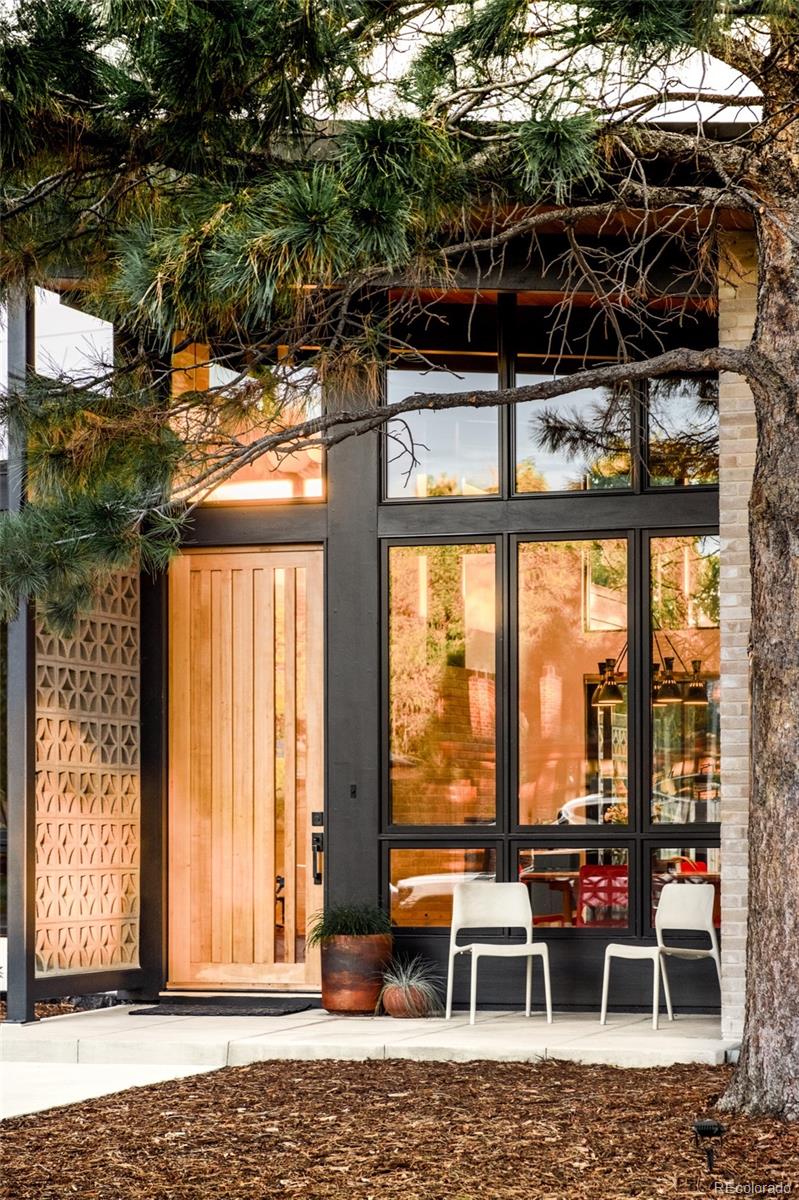 2977 Forest Street Denver, CO 80207 - Photo 2 of 23 a couple of chairs and a table in a patio