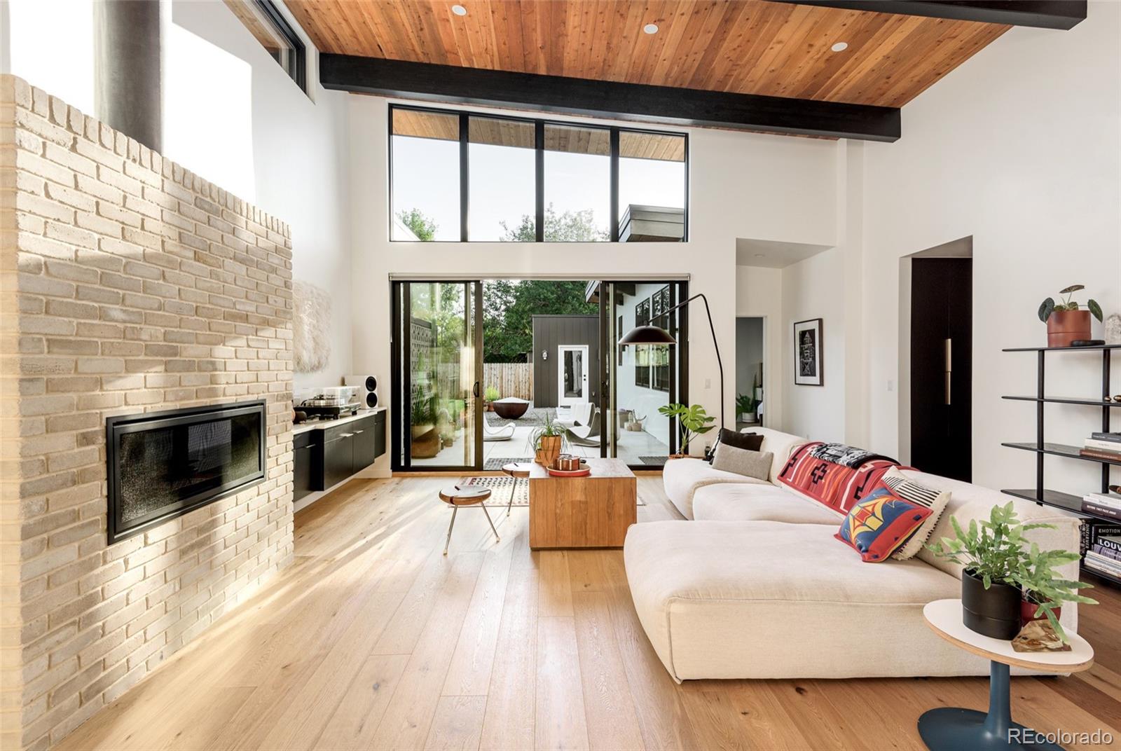 2977 Forest Street Denver, CO 80207 - Photo 3 of 23 a living room with furniture and a fireplace