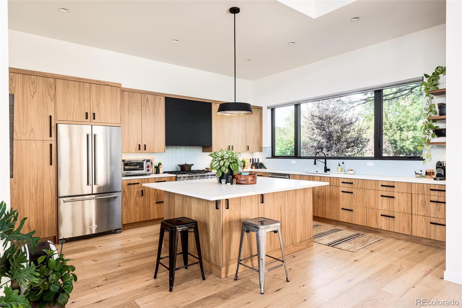2977 Forest Street Denver, CO 80207 - Photo 5 of 23 a kitchen with white cabinets appliances and furniture