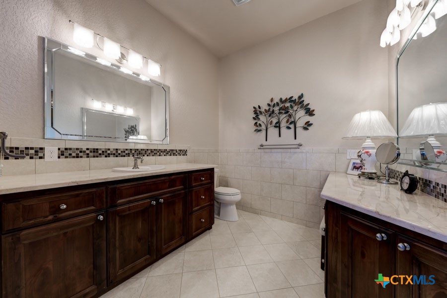 2420 Bolton Road Marion, TX 78124 - Photo 12 of 30 a bathroom with a sink vanity and a mirror
