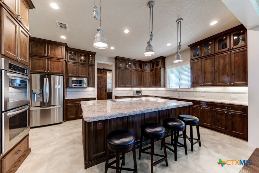 2420 Bolton Road Marion, TX 78124 - Photo 4 of 30 a large kitchen with a table and chairs
