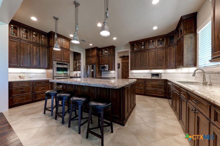 2420 Bolton Road Marion, TX 78124 - Photo 5 of 30 a kitchen with lots of counter space a sink and appliances