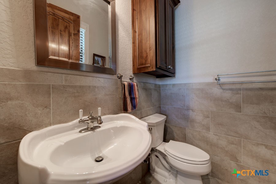2420 Bolton Road Marion, TX 78124 - Photo 7 of 30 a bathroom with a sink and mirror