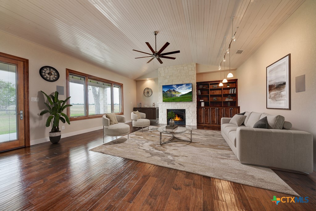 2420 Bolton Road Marion, TX 78124 - Photo 8 of 30 a living room with furniture a fireplace and a large window
