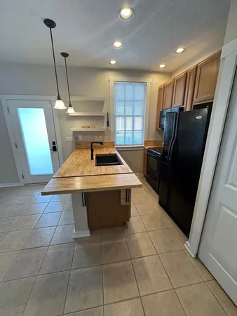 a kitchen with a sink a refrigerator and window