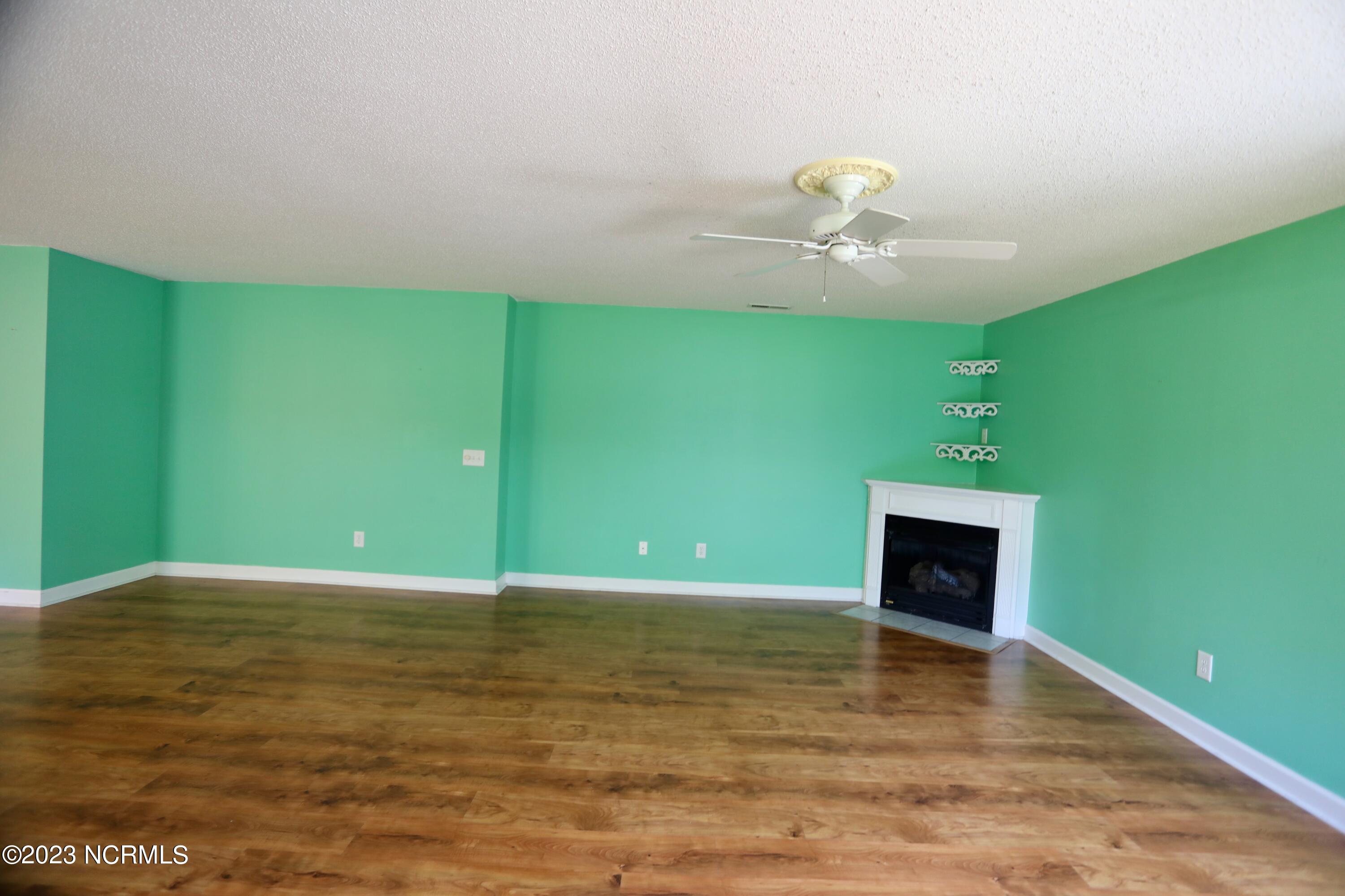 545 Pinehurst Trace Drive Pinehurst, NC 28374 - Photo 22 of 32 Wood type flooring surrounds corner Fire Place