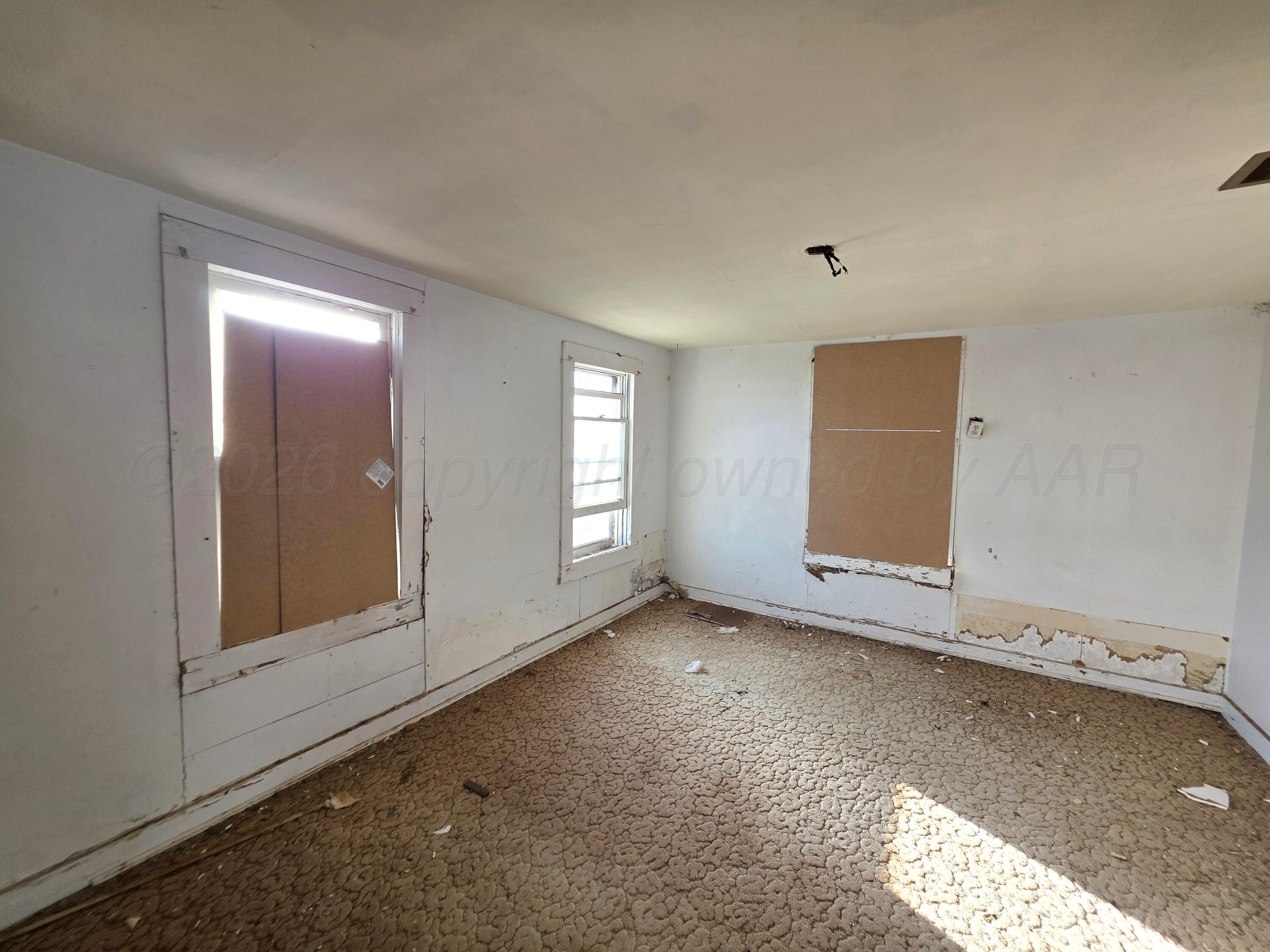 919 Main Street McLean, TX 79057 - Photo 8 of 13 a view of empty room with window