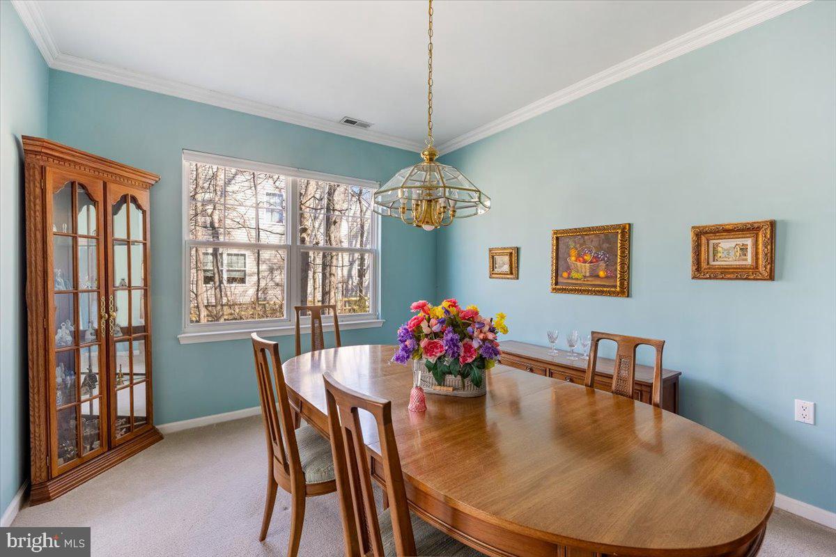 131 Lowell Drive Marlton, NJ 08053 - Photo 15 of 60 a dining room with furniture a chandelier and window