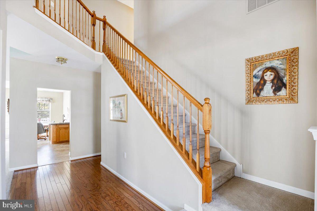 131 Lowell Drive Marlton, NJ 08053 - Photo 16 of 60 a view of staircase with wooden floor and a rug