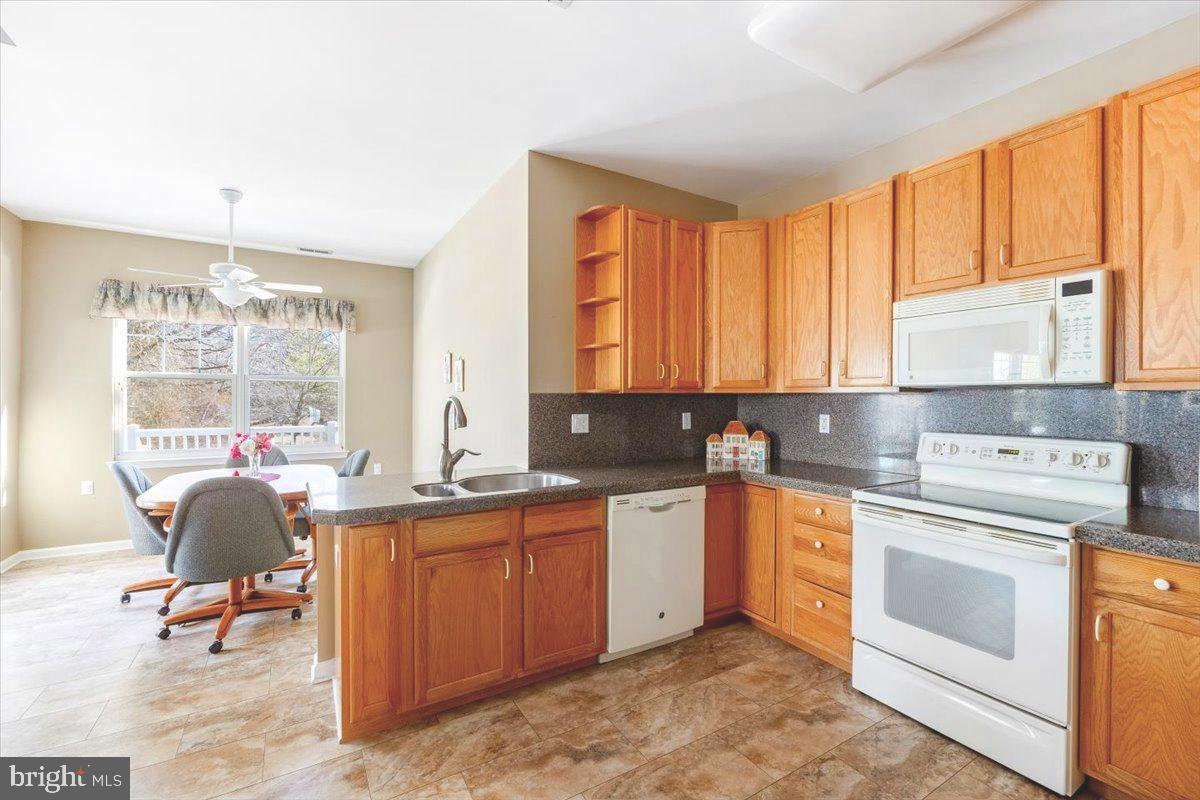131 Lowell Drive Marlton, NJ 08053 - Photo 22 of 60 a view of a kitchen with a sink cabinets and wooden floor