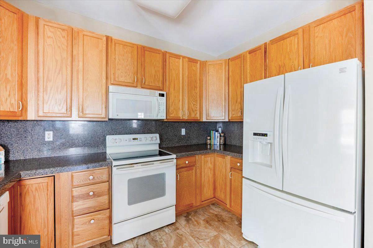 131 Lowell Drive Marlton, NJ 08053 - Photo 23 of 60 a kitchen with stainless steel appliances white cabinets and a refrigerator