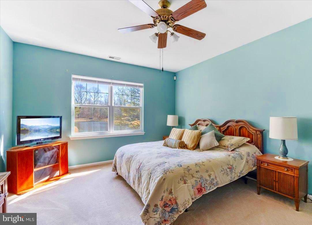 131 Lowell Drive Marlton, NJ 08053 - Photo 29 of 60 a bedroom with a bed and a chandelier