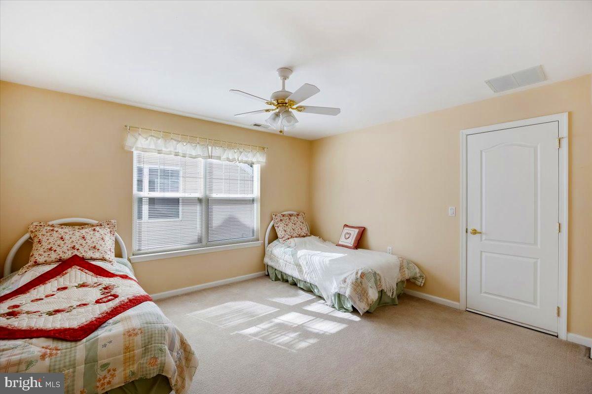 131 Lowell Drive Marlton, NJ 08053 - Photo 37 of 60 a bedroom with a bed and a chandelier