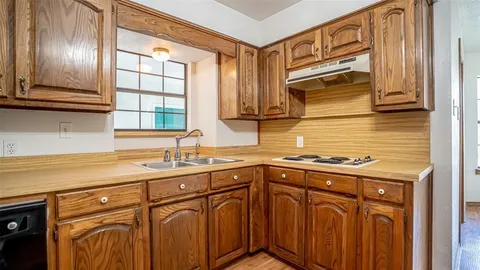 a kitchen with stainless steel appliances granite countertop a sink and cabinets