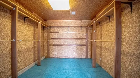 a view of hallway with shower and a mirror