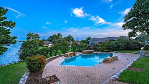 a view of a swimming pool with a yard