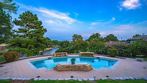 a view of a swimming pool with a yard