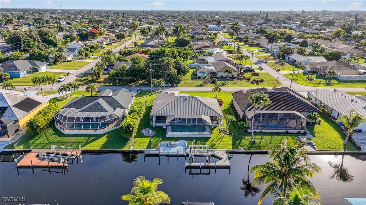 4306 Southwest 3rd Avenue Cape Coral, FL 33914 - Photo 38 of 50 an aerial view of residential houses with outdoor space and parking