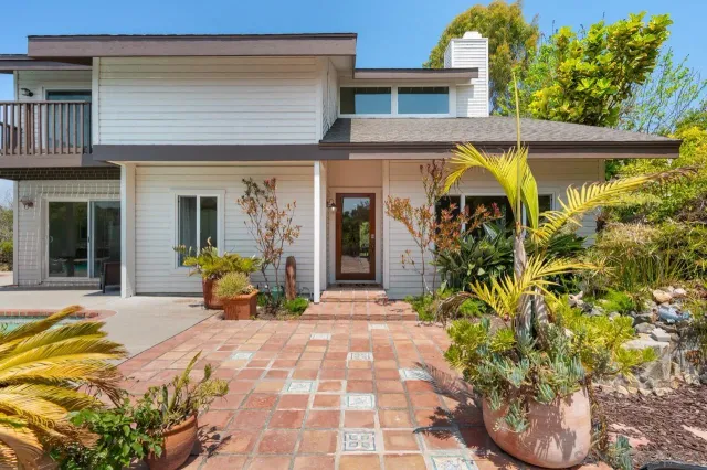 a living room with furniture and stairs