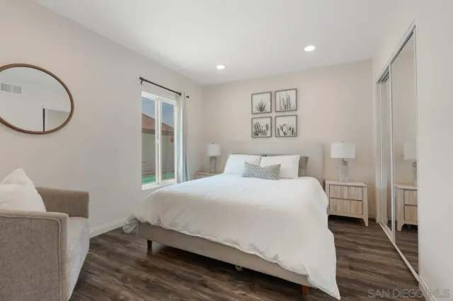 a kitchen with kitchen island granite countertop wooden cabinets and white appliances
