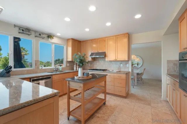 a bathroom with a granite countertop sink a large mirror and vanity