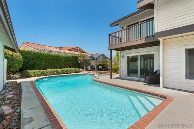 a view of a white house with a yard and plants