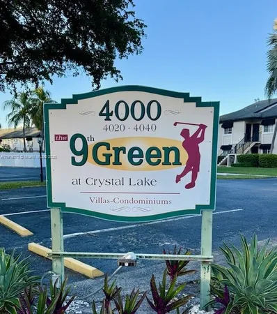 a sign on a street next to a yard