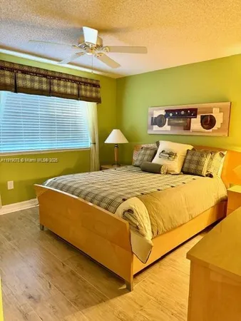 a bedroom with bed and a window