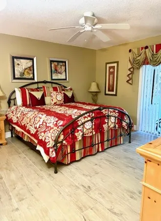 a bedroom with a bed and a painting on the wall