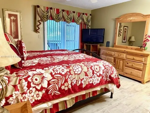 a bedroom with a bed and a dresser in it