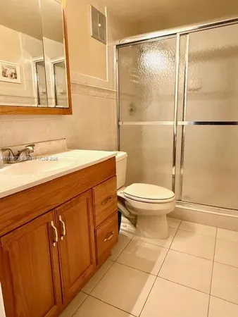 a bathroom with a sink a toilet and a shower