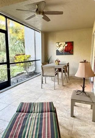 a living room with a rug floor view and a large window