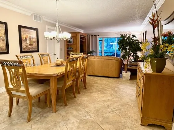 a view of a dining room with furniture and a chandelier