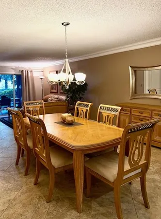 a dining room with furniture and chandelier