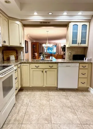 a kitchen with stainless steel appliances granite countertop a stove and a sink