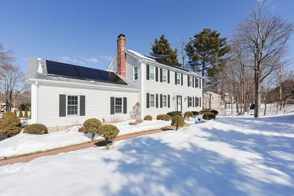 a view of a house with snow in front of it