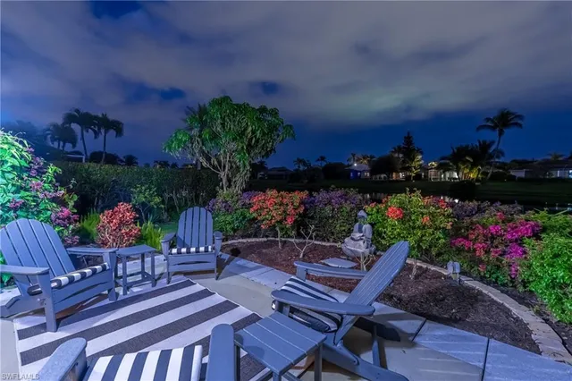 a view of a patio with table and chairs and potted plants