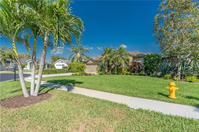 a view of a chairs and table in a backyard