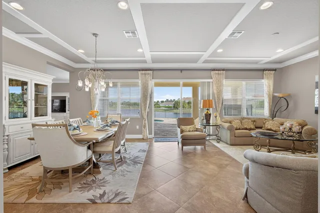 a kitchen with stainless steel appliances granite countertop table chairs sink and cabinets