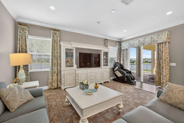 a kitchen with a refrigerator and white cabinets