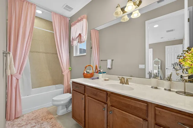 a front view of a house with a garden and plants