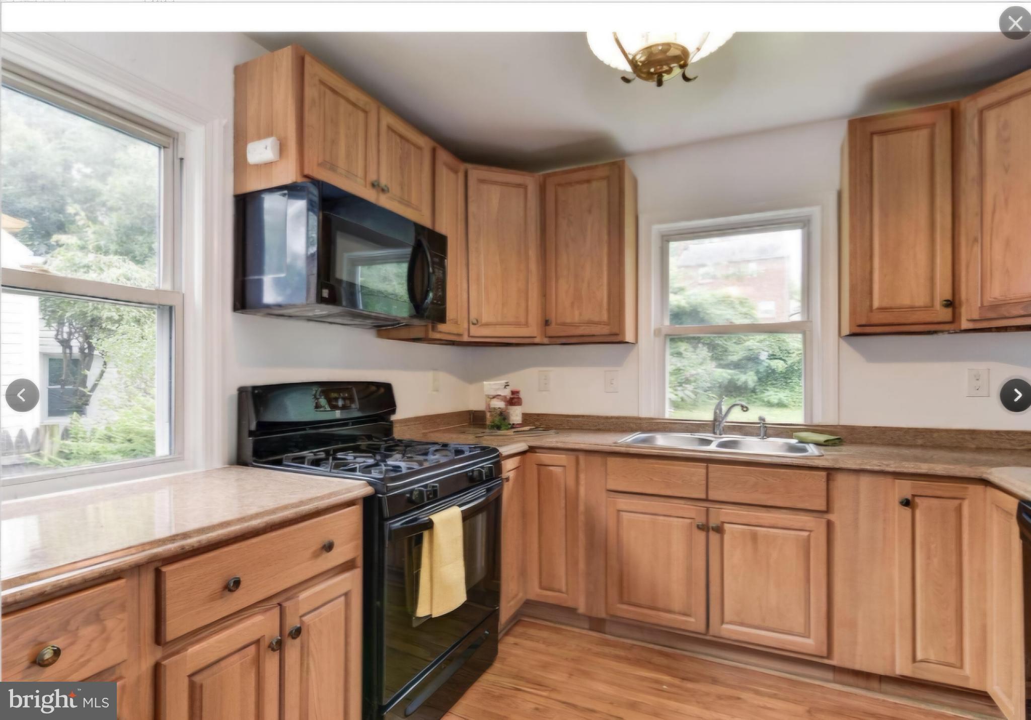 10407 Grandin Road Silver Spring, MD 20902 - Photo 4 of 13 a kitchen with cabinets appliances a sink and a window