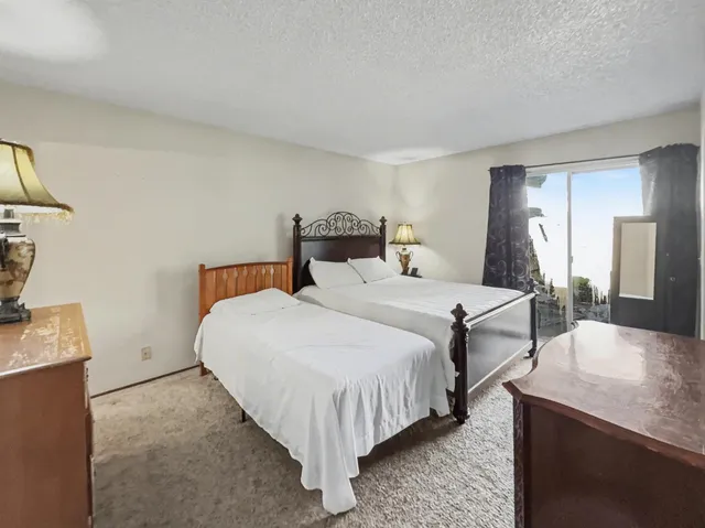 a bedroom with bed and a night stand