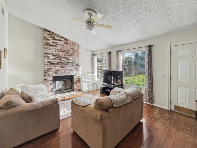 a living room with furniture and a fireplace