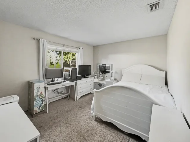 a bedroom with a bed and a couch