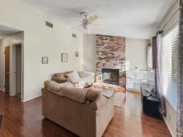 a living room with furniture and a fireplace