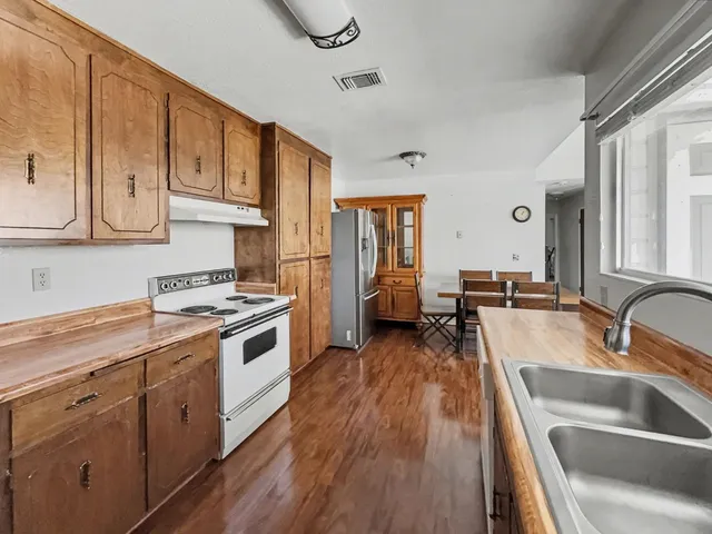 a kitchen with a stove a sink and a refrigerator