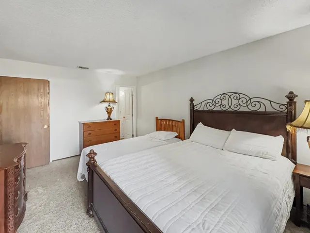 a bedroom with a bed and a dresser