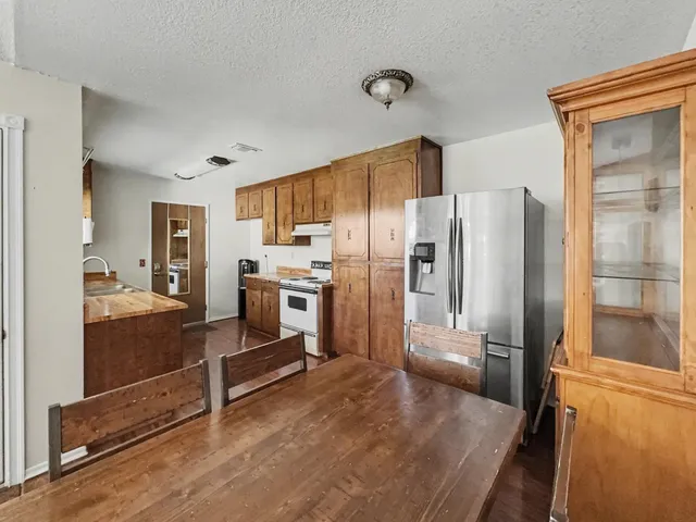 a kitchen with stainless steel appliances a refrigerator and a stove top oven